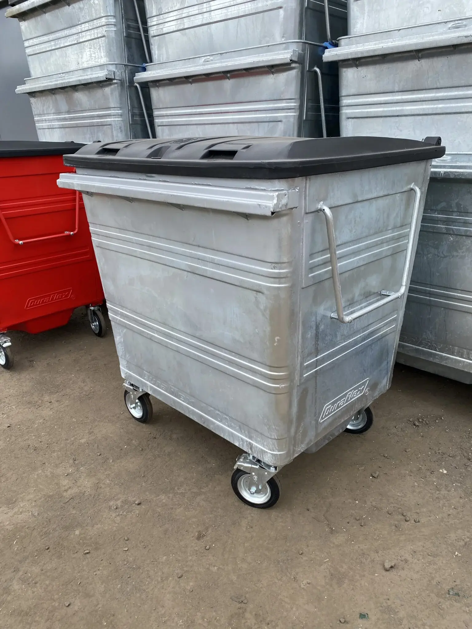 close up of finished and unpainted wheelie bins